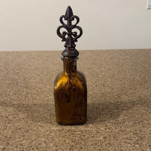 Amber Swirl Glass Bottle with Decorative Fleur-de-Lis Stopper